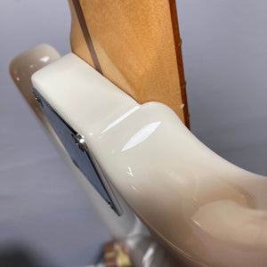Close-up of the neck joint on a used Fender Mustang Player Bass PJ in white, highlighting the glossy cream body and natural neck wood. The image showcases the iconic short-scale design by Fender.