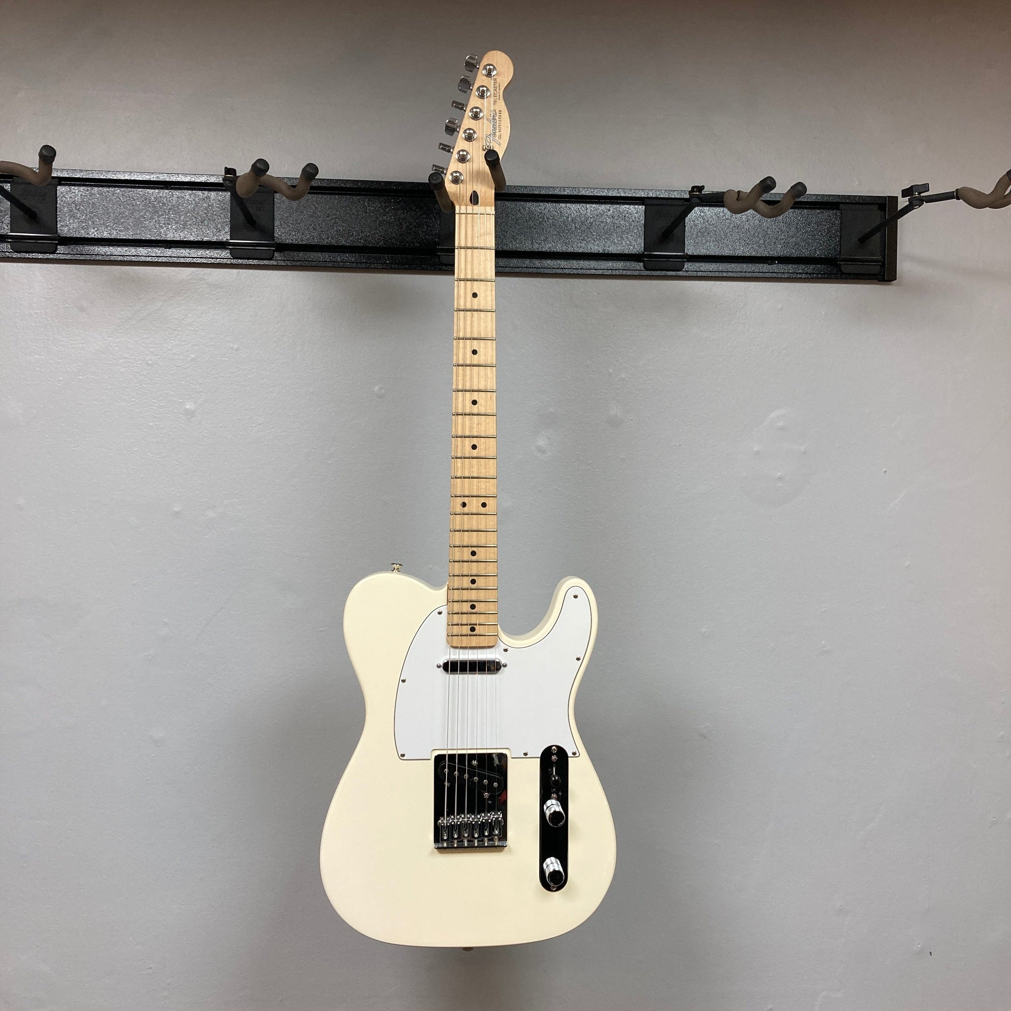 Fender Standard Telecaster 2008 Arctic White, featuring black knobs and a maple neck, known for its classic tone and sleek design.