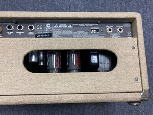 Close-up of a Fender Super Sonic 60-Watt Amp Head, showcasing its dual channels and control knobs.