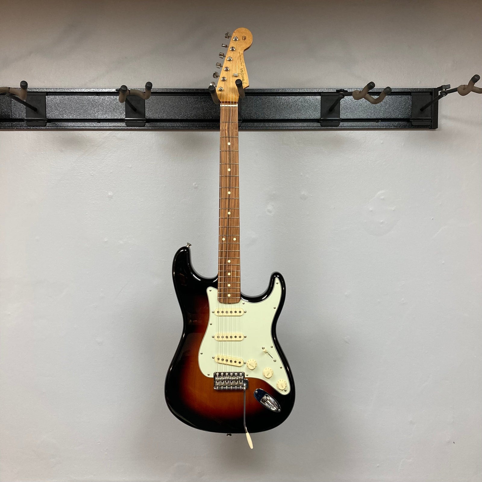Fender Vintera '60s Stratocaster 3-Tone Sunburst Refurb w/Gigbag, showcasing the guitar's body and neck, highlighting its classic design and vintage-style features.