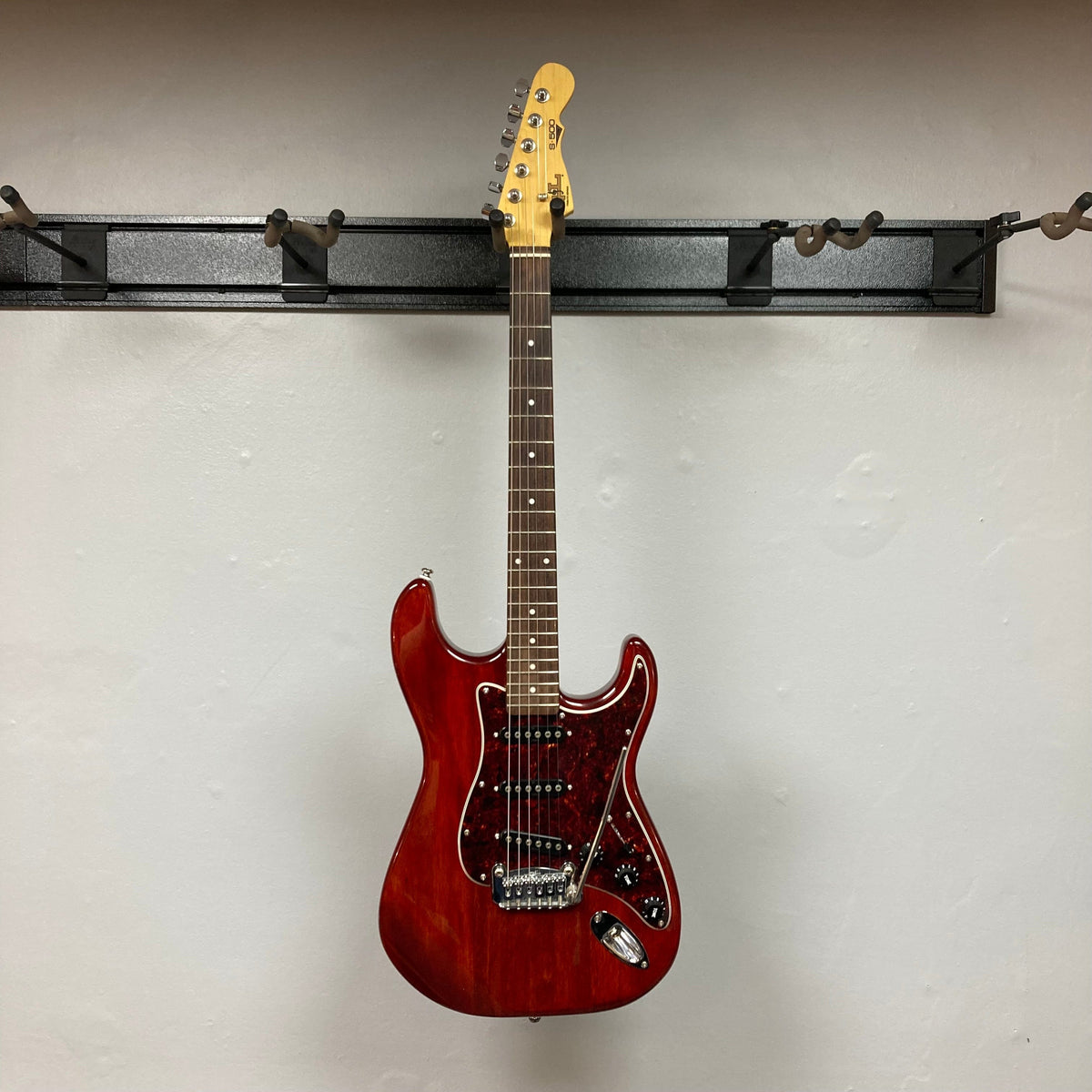 G&amp;L Tribute Series S-500 Irish Ale Used, electric guitar on a stand, close-up showing maple neck and rosewood fingerboard.