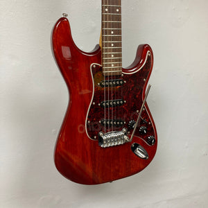 G&L Tribute Series S-500 Irish Ale Used, red electric guitar with nato body, maple neck, and rosewood fingerboard, displayed on a wall.