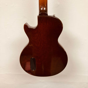 Rear view of a Gibson Les Paul Junior 1957 Sunburst electric guitar by Gibson, featuring a dark wood body with a single cutaway, displayed against a plain white background.