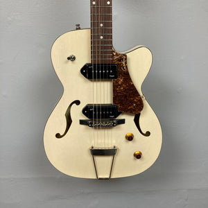 Godin 5th Ave TL Kingpin P90 guitar with gold specks, showcasing its distinctive design and hollow body, ideal for versatile musical expression.