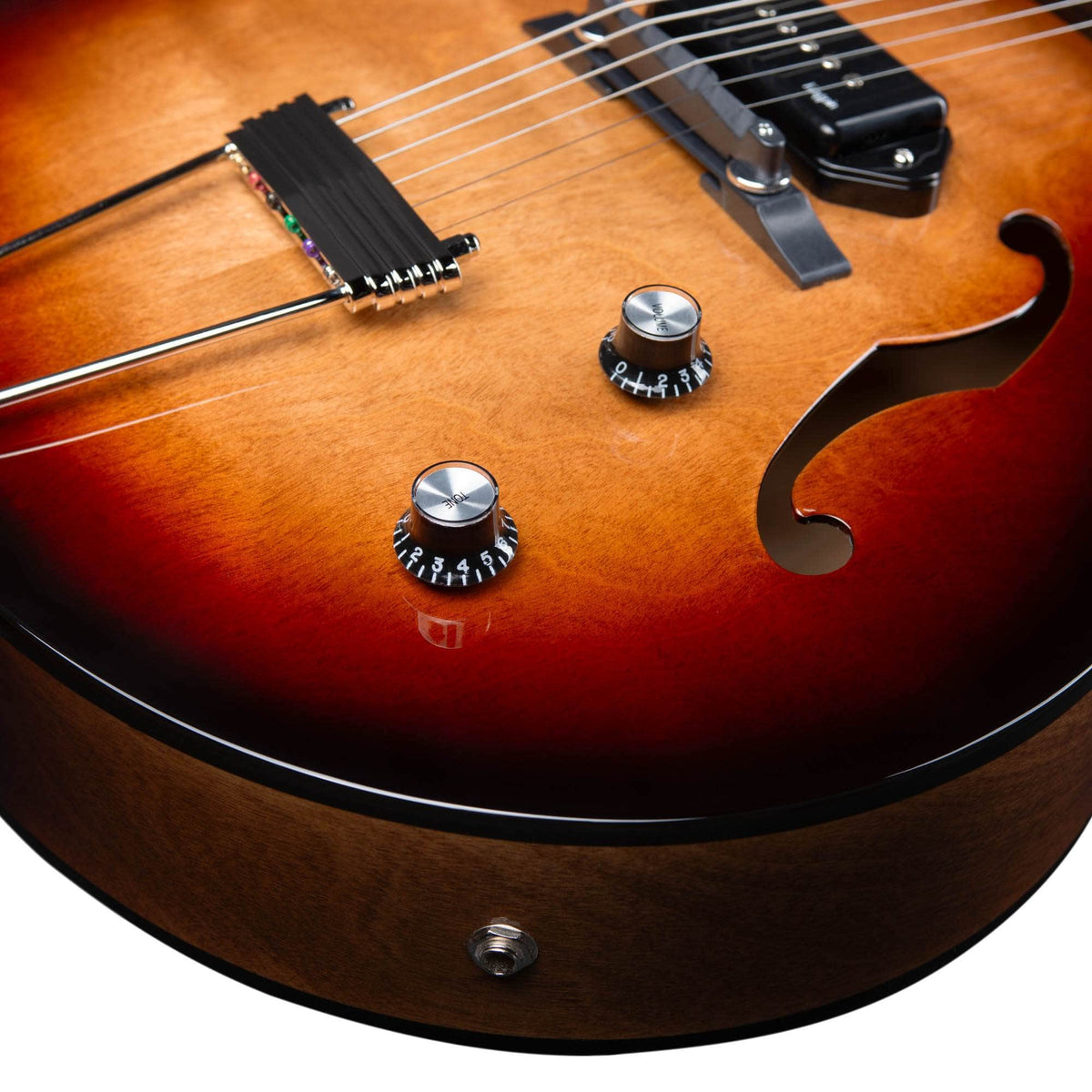 Close-up of the Godin 5th Avenue Kingpin II DLX Vintage Burst HG SF, a semi-hollow electric guitar expertly crafted in Canada, featuring P90 single-coil pickups, two control knobs, strings, and f-hole detail.
