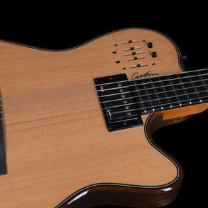 Close-up of a Godin A6 Ultra Deluxe Natural w/Gigbag acoustic-electric guitar body featuring a natural wood top, a humbucker pickup, and integrated tone sliders.