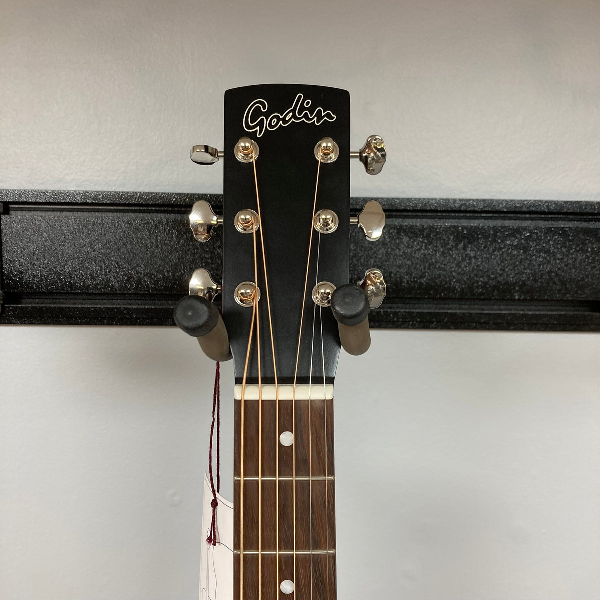 Godin Mahogany Parlor Black Burst A/E guitar on a stand with close-ups of strings and neck.