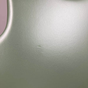 Close-up of the Godin Radium Matte Green RN SF w/GigBag’s smooth, matte surface by Godin, highlighting a small central indentation and subtle H-S-H tonal details.