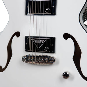 Close-up of a white Godin Rik Emmett Premiere Electric Guitar, showcasing chrome hardware, black "TRIUMPH" pickups, and distinctive f-hole cutouts—striking features from this limited edition Godin signature model.