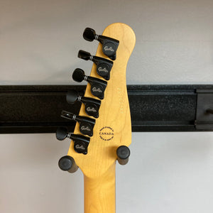 Close-up of the Godin Session R-HT Pro Retro Orange guitar headstock with black tuning knobs and vintage Godin logo.