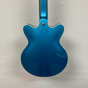 Back view of a Gretsch G2655TG Streamliner Riviera Blue Refurb semi-hollow electric guitar with cream-colored binding, set against a plain white wall.