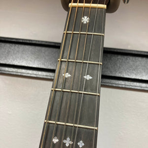 Close-up of the Guild Gad-30reasb w/Case guitar neck, featuring strings, frets, and decorative inlays on a solid Indian rosewood fingerboard, set against a white wall background.