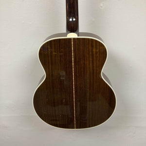 Rear view of a Guild USA F-512 w/OHSC 2005 Circa jumbo 12-string acoustic guitar featuring a dark wood finish, cream edge binding, and a decorative center strip.