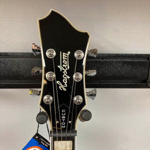 The headstock of the Hagstrom Fantomen Custom Black w/case electric guitar by Hagstrom features six tuning pegs, a silver logo, and “CUSTOM” written vertically.