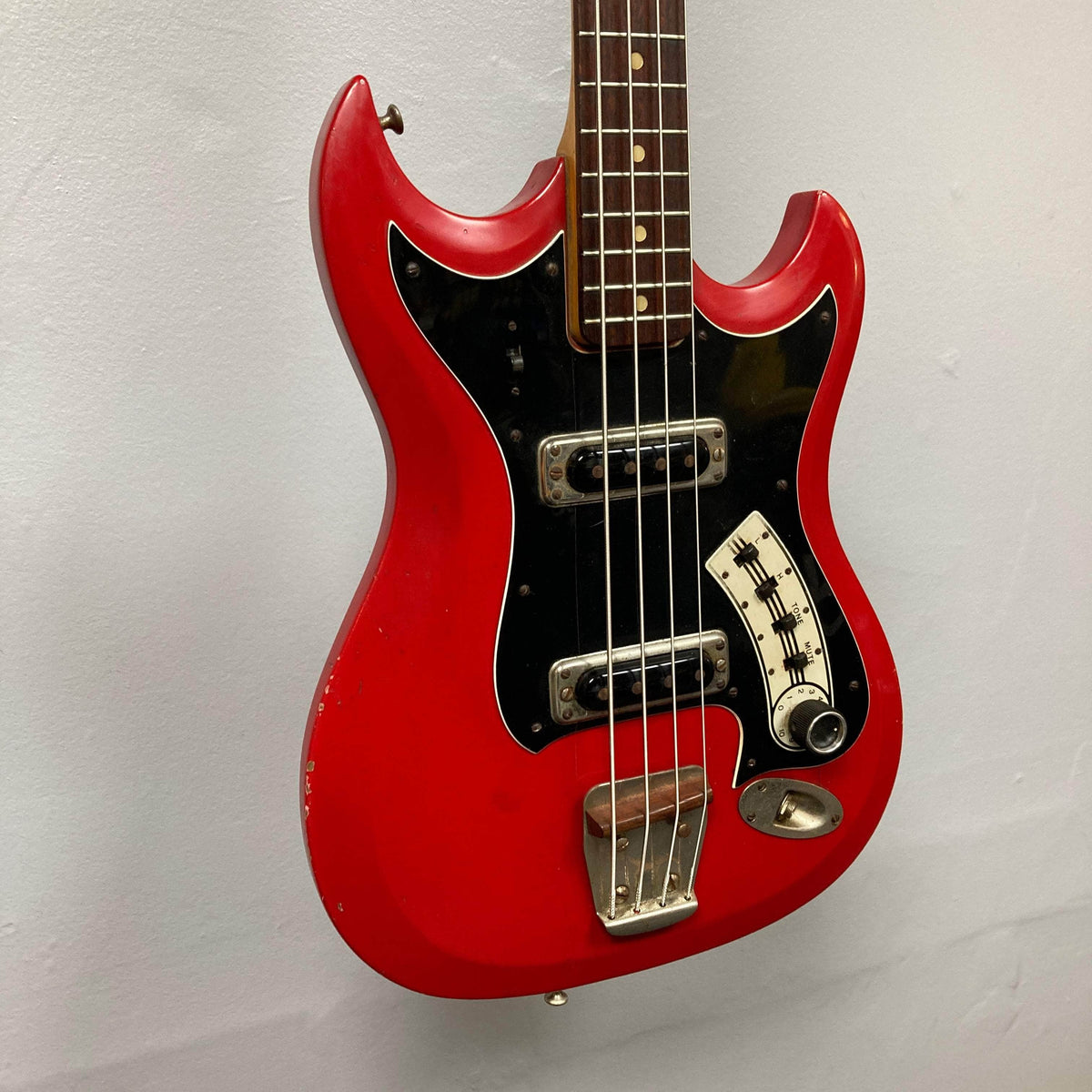 Hagstrom HII-B Mid-1960s Red Medium-Scale Bass with black pickguard, two pickups, and vintage patina, showcasing unique Scandinavian design and original hardware.