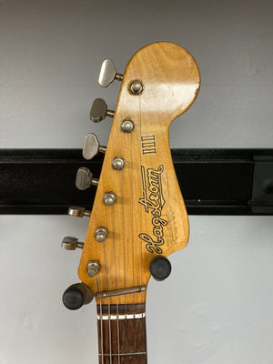 Hagstrom III 1960s sunburst electric guitar close-up, showcasing the neck, metal knobs, and vintage craftsmanship, with original case included.