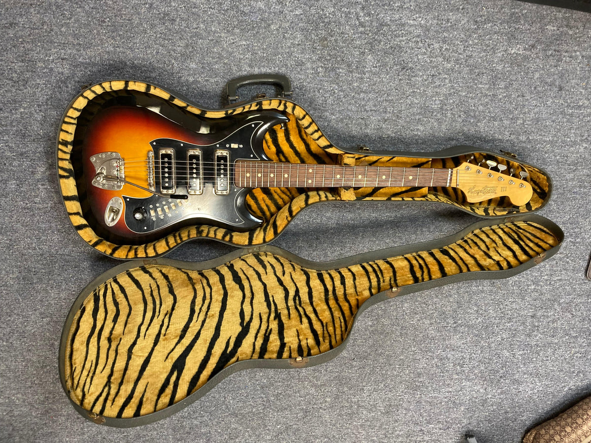 Hagstrom III 1960s Sunburst Electric Guitar in original case, showcasing a vintage design.