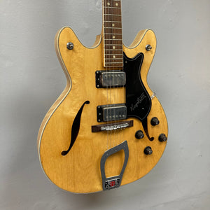 Hagstrom Viking 1968 Natural guitar displayed on a wall, showcasing its vintage design, distinct body shape, and detailed craftsmanship.