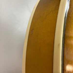 Close-up of the Harmony H-75 1960s Sunburst guitar highlighting its sunburst finish and wood grain texture.