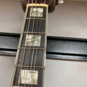 Harmony H-75 1960s Sunburst guitar close-up showing strings and neck, highlighting minor finish blemishes and classic sunburst design.