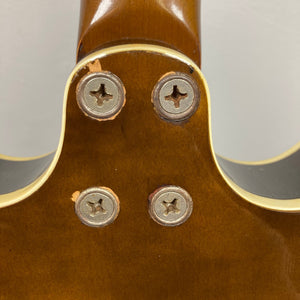 Harmony H-75 1960s Sunburst guitar, close-up of screws and body finish, highlighting minor blemishes. Perfect for versatile musical styles. Consignment sale item, no returns.