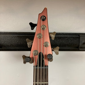 Ibanez Ergodyne Eda 905 5-string Bass, featuring a close-up of the guitar head, pegs, and bridge with Fishman Piezo pickups.