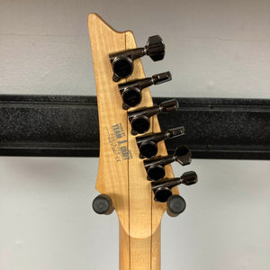Close-up of the Ibanez Prestige RG1570 Cosmic Blue's headstock, showing six black tuning pegs, manufacturer labels, and the signature Wizard Prestige neck. Includes case. Brand: Ibanez.
