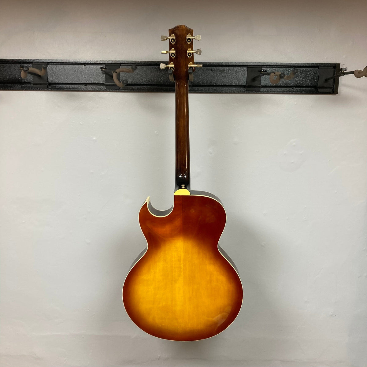 Ibanez Starfield hollow body guitar with humbucker neck pickup, displayed hanging on a wall.