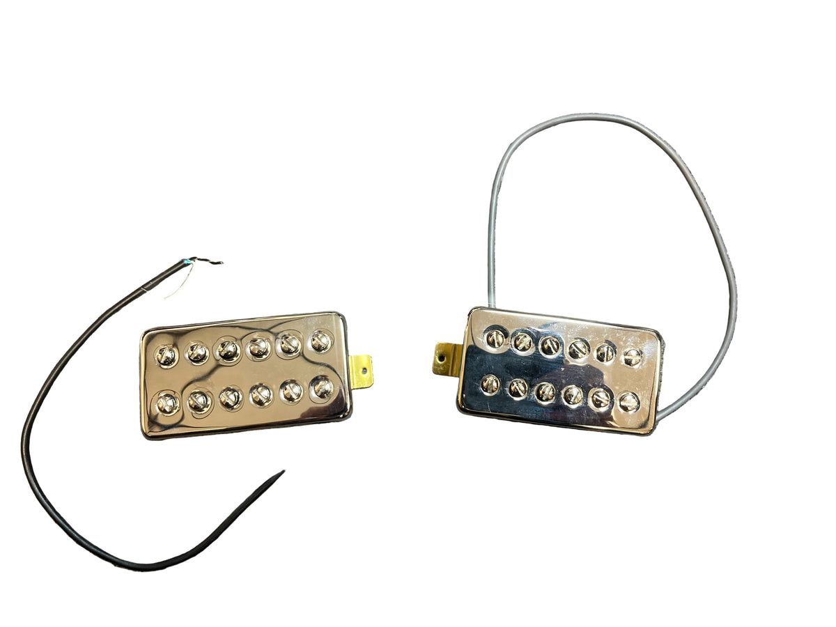The TV Jones Powertron Neck and Bridge Pickup Set - Chrome (New Old Stock) features chrome-covered humbuckers with exposed pole pieces and black/white wiring, delivering the classic Gretsch-inspired sound.