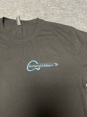 Close-up of Guitars on Main logo on black t-shirt