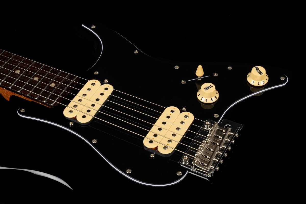 Close-up of the Jet JS-400 BKR H electric guitar by Jet, showcasing its sleek black body, cream-colored control knobs, and dual ceramic HH pickups designed for modern playability. The guitar features a brown neck and is presented against a black background.