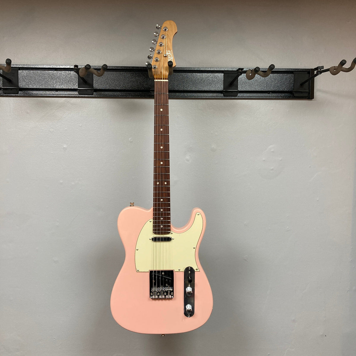 Jet JT-300 guitar, pink body with chrome hardware, showcasing its modern craftsmanship and design, ideal for players seeking quality and affordability.