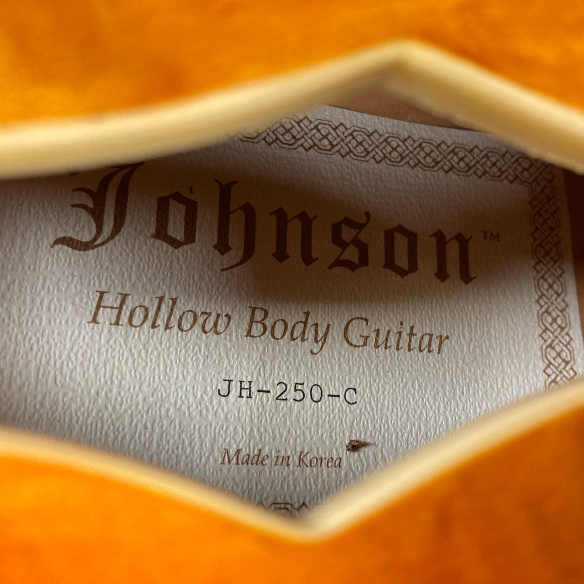 Johnson JH-250-C Semi Hollow Cherry Burst guitar label, highlighting model details and craftsmanship close-up. Perfect for enthusiasts at Guitars on Main.