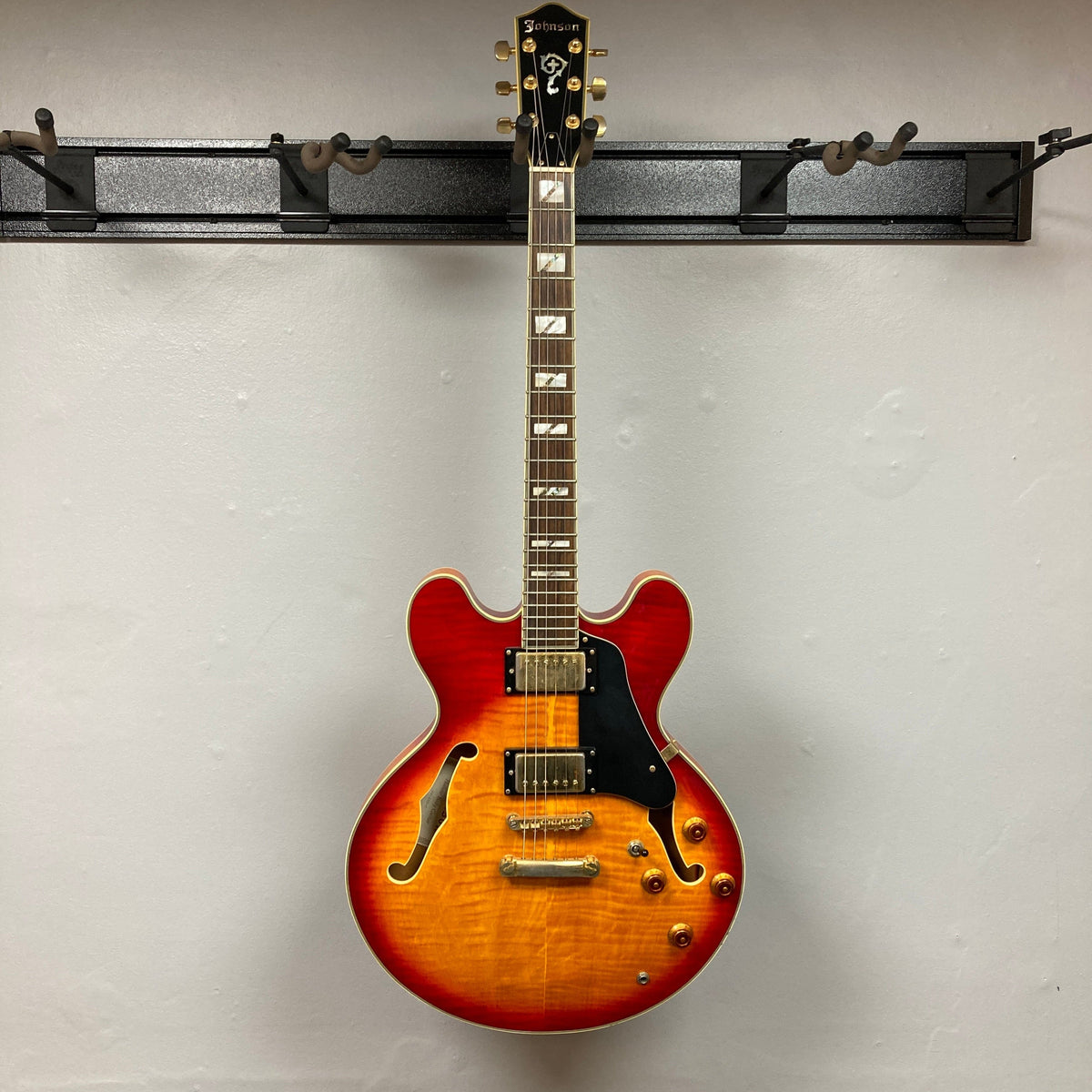 Johnson JH-250-C Semi Hollow Cherry Burst guitar displayed vertically, highlighting its body and neck, suited for enthusiasts at Guitars on Main.