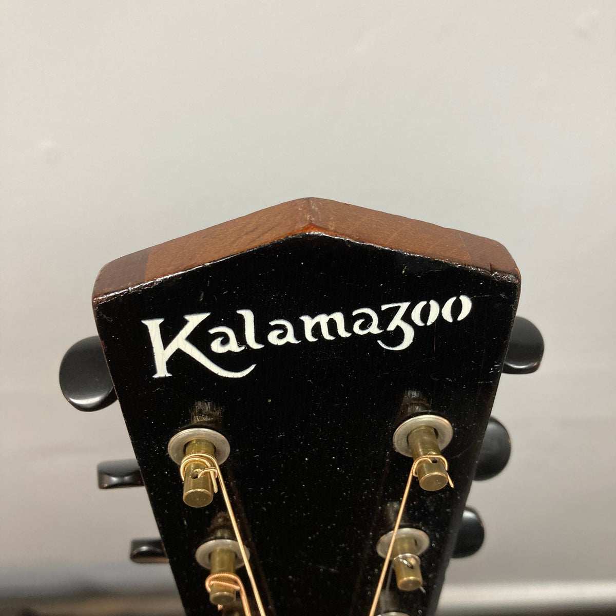 Back view of a vintage Kalamazoo KG-14 Sunburst guitar, showcasing its restored neck joint and bridge.