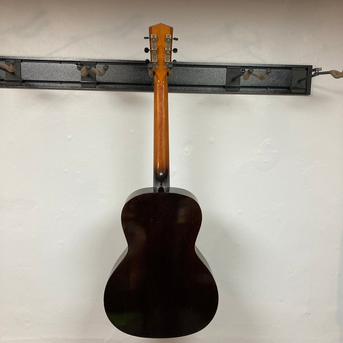 Kalamazoo KG-14 1930s-1940s Sunburst guitar displayed on a wall, highlighting vintage charm and meticulous restoration.