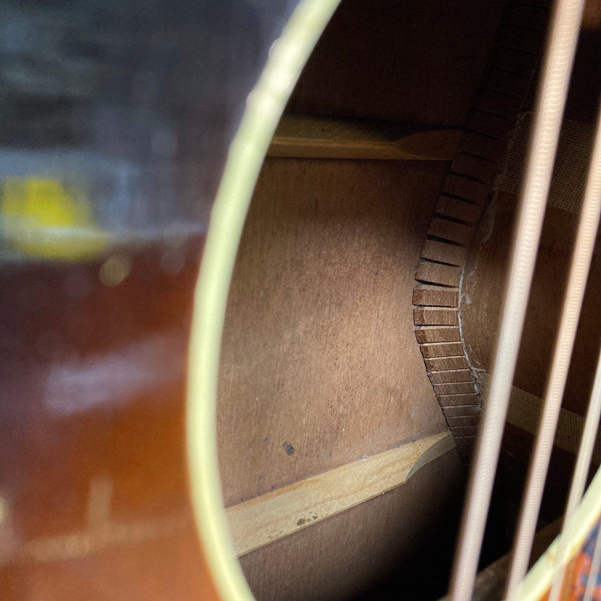 Close-up of a vintage Kalamazoo KG-14 1930s-1940s Sunburst guitar, showcasing its finely restored wooden body and intricate string details.