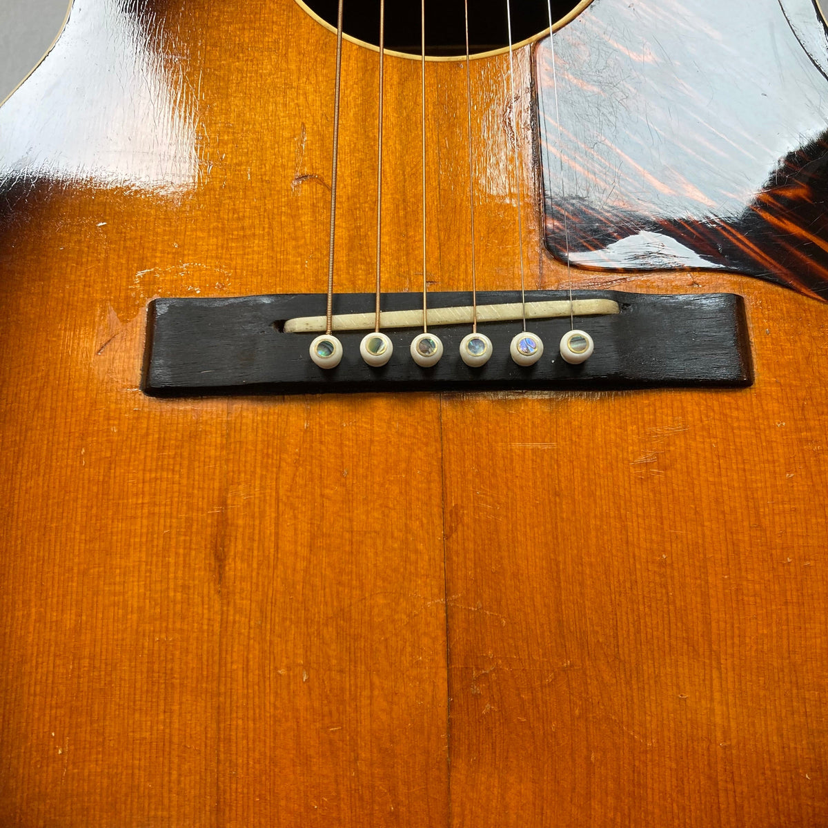 Close-up of a restored Kalamazoo KG-14 1930s-1940s Sunburst guitar, highlighting strings and wooden finish.