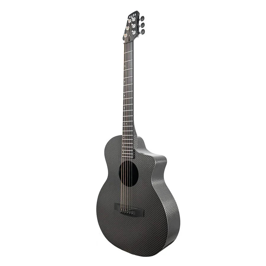 The Klos Full Carbon Grand Cutaway Mini DAE w/Fishman Presys VT, a black carbon fiber travel guitar with six strings and a glossy finish, stands upright against a white background.