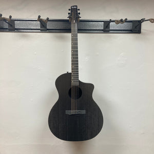 KLOS Grand Cutaway Acoustic Guitar w/Fishman Sonitone Piezo, black, leaning against a white wall, showcasing its sleek design and durability.