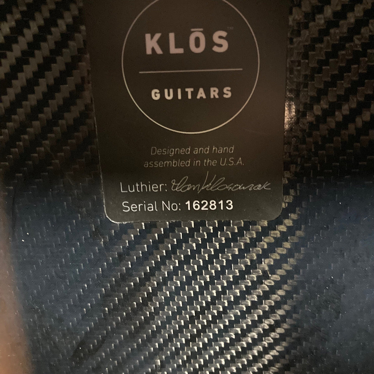 KLOS Grand Cutaway Acoustic Guitar: durable carbon fiber body, white text label, and advanced design for versatile playability. Ideal for musicians seeking resilience and rich sound.