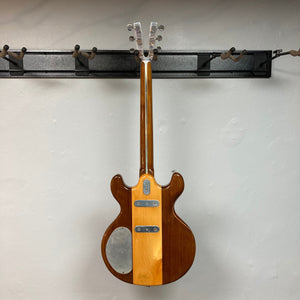 Kramer 650G Deluxe 1986 guitar on a wall hook, showcasing vintage craftsmanship with metal plates and high-quality pickups.