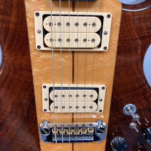 Close-up of the Kramer DMZ 6000-G Natural guitar, highlighting its strings, aluminum neck with wooden inserts, and DiMarzio Dual Sound pickups.