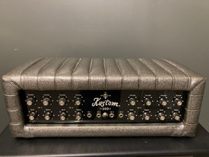 Kustom 200 1970's Champagne Silver Sparkle Tuck And Roll Tolex Amp Head, featuring a sleek silver and black design, shown in close-up detail.