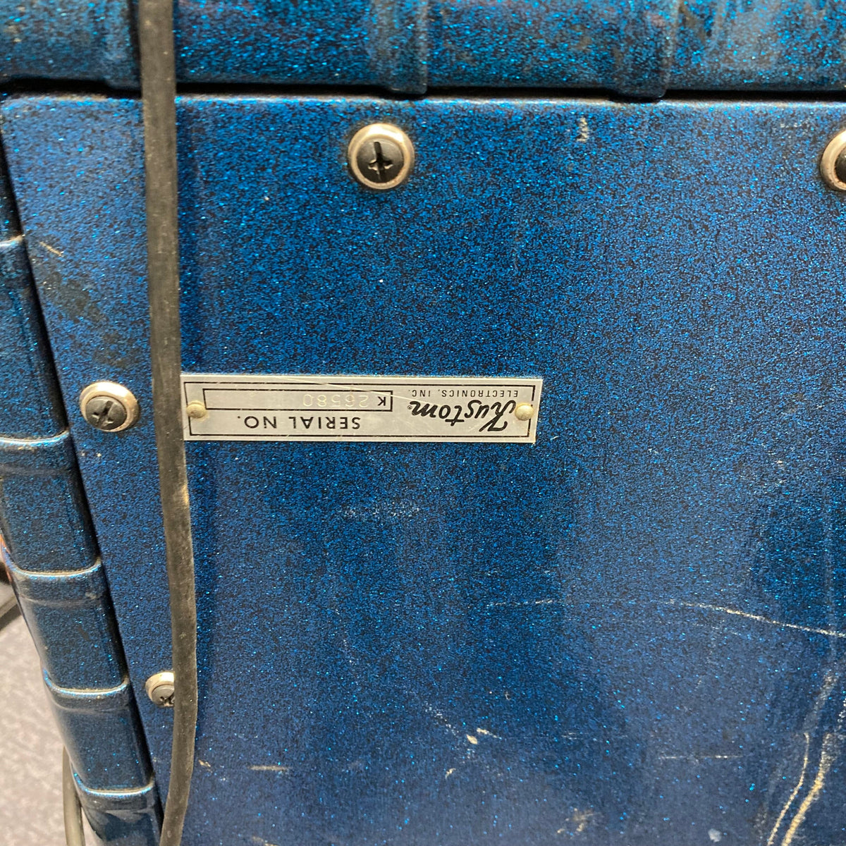 Kustom K200-B2 Blue Head and Cabinet Amp with black cord, metal surface, screws, and keyhole for versatile, powerful guitar amplification.