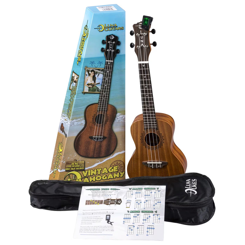 The Luna Vintage Mahogany Concert Ukulele Pack includes a mahogany ukulele, tuner, instructional sheet, soft bag, and branded box with tropical graphics labeled "Vintage Mahogany.