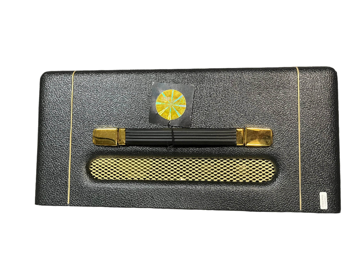 A black, rectangular case with gold accents, gold mesh panel, two gold latches, black handle, and a yellow-green sticker above the handle—ideal for carrying your Marshall Studio Vintage SV20H MKII 20/5-Watt Tube Head by Marshall.