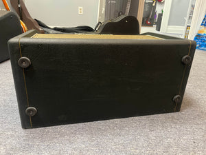 The underside of a 1969 Marshall 4x12 Cabinet with Matching Celestion T1281 Greenbacks, featuring four rubber feet, is shown resting on a gray carpeted floor.