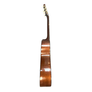 Side view of a Martin 00-18G Classical Guitar, c. 1961–1962, with brown wooden body, nylon strings, glossy finish, visible neck and tuning pegs against a white background.
