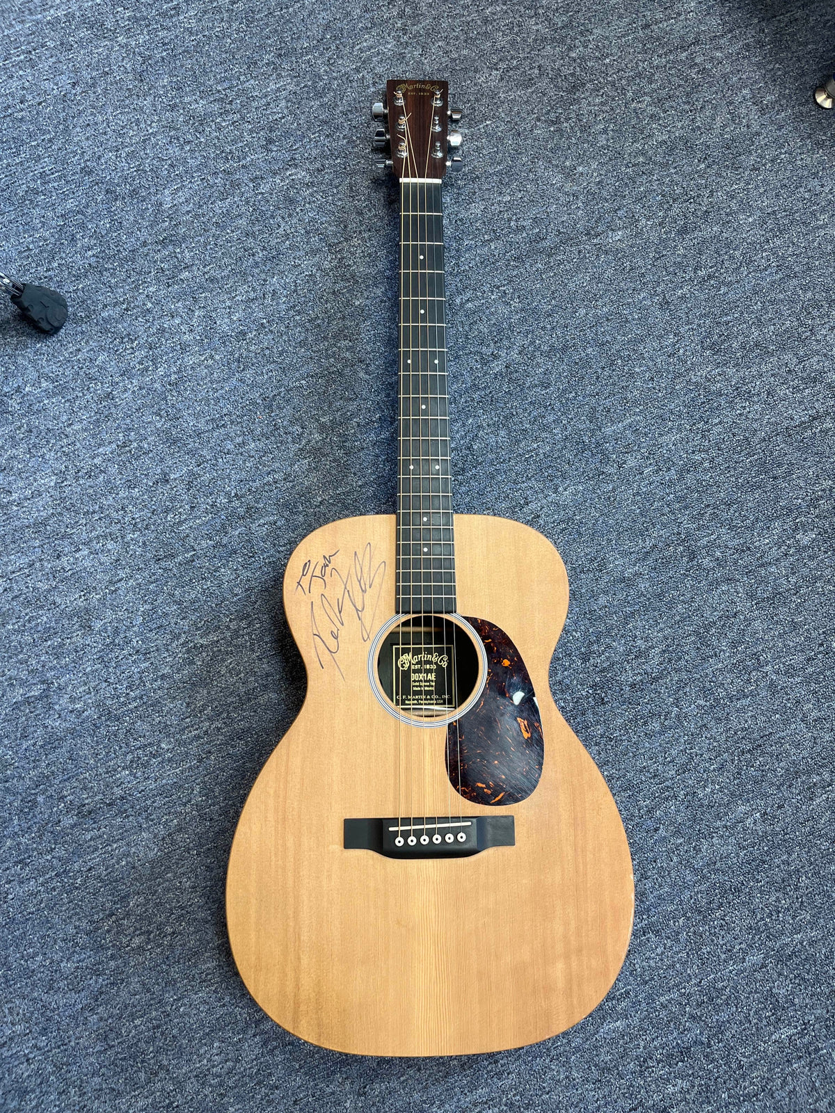 Martin 00X1AE Acoustic-Electric Guitar featuring a Richie Kotzen autograph on the body near the sound hole.